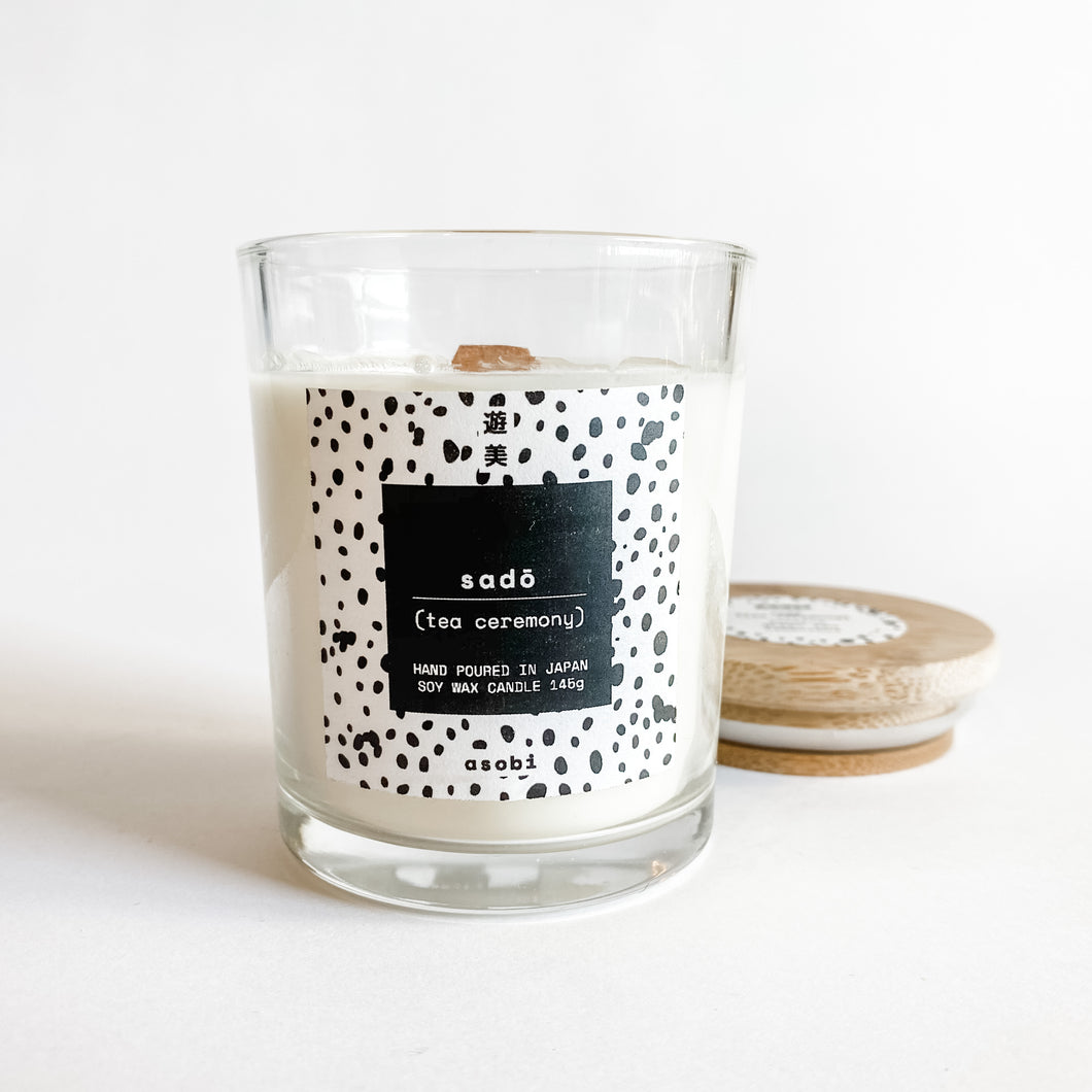 Soy wax candle in clear glass jar with white washi label with black polka dots with bamboo lid 